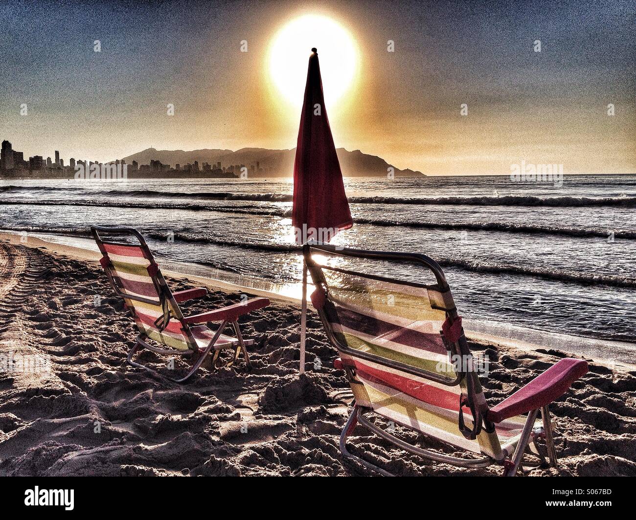Deck chairs and umbrellas on Spanish beach front Stock Photo Alamy
