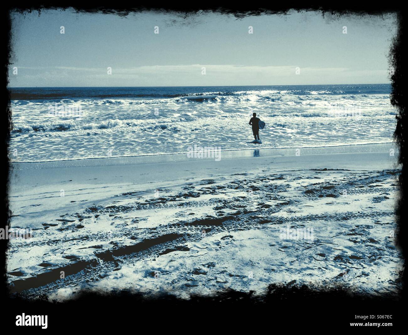 A surfer at Jacksonville Beach, Florida, USA - Smartphone Captured Stock Image