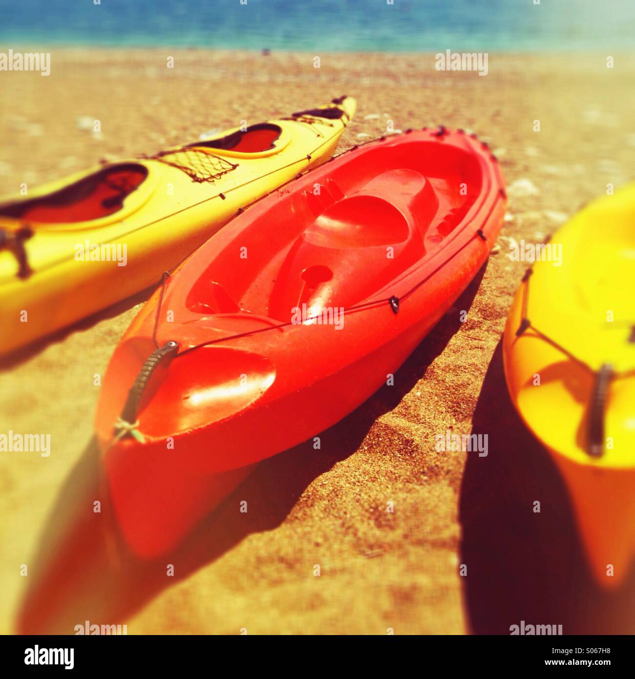 Three kayaks on a beach Stock Photo