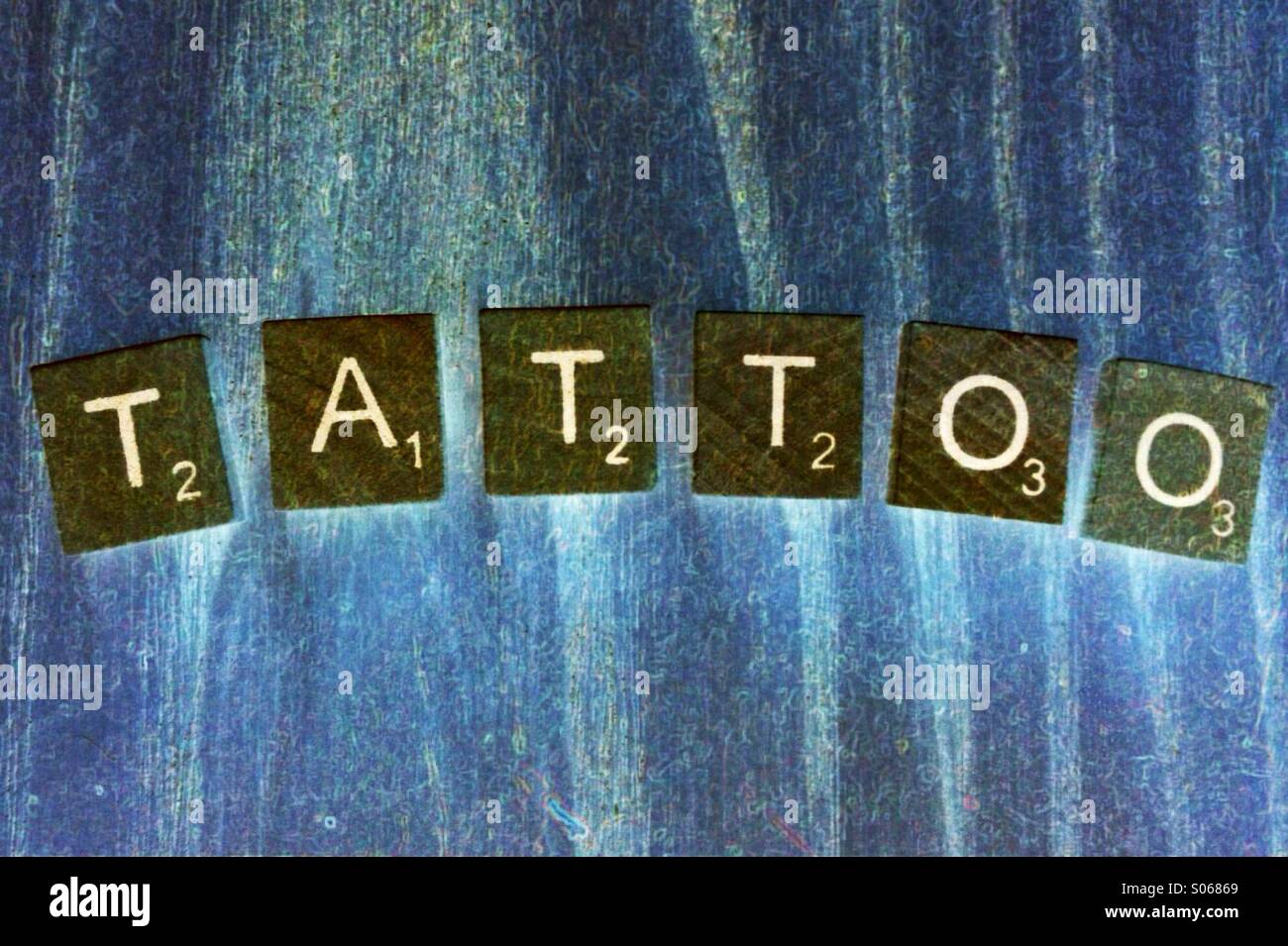 Letters spelling the word tattoo - Smartphone Captured Stock Image