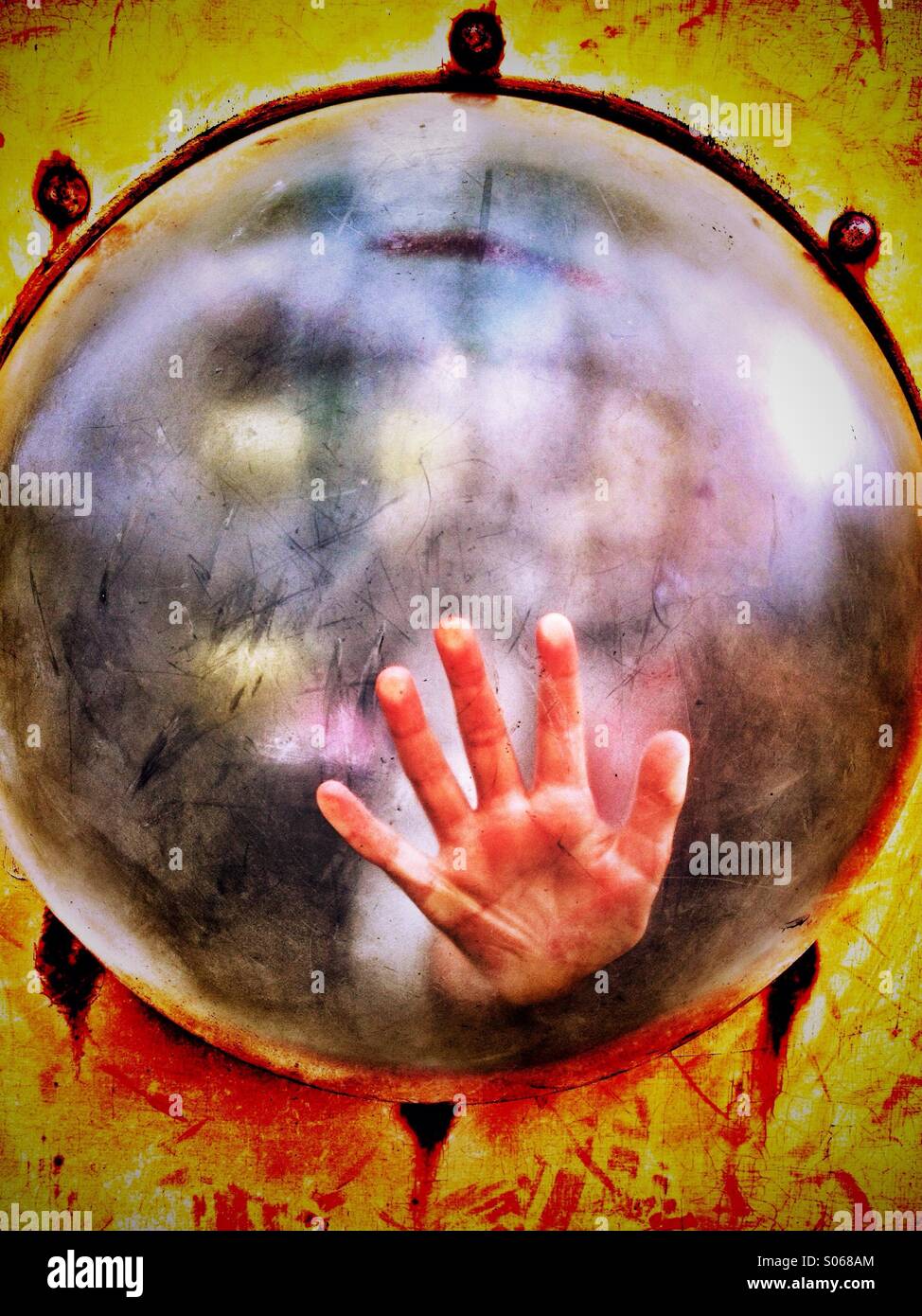 Child's hand on plastic bubble Stock Photo