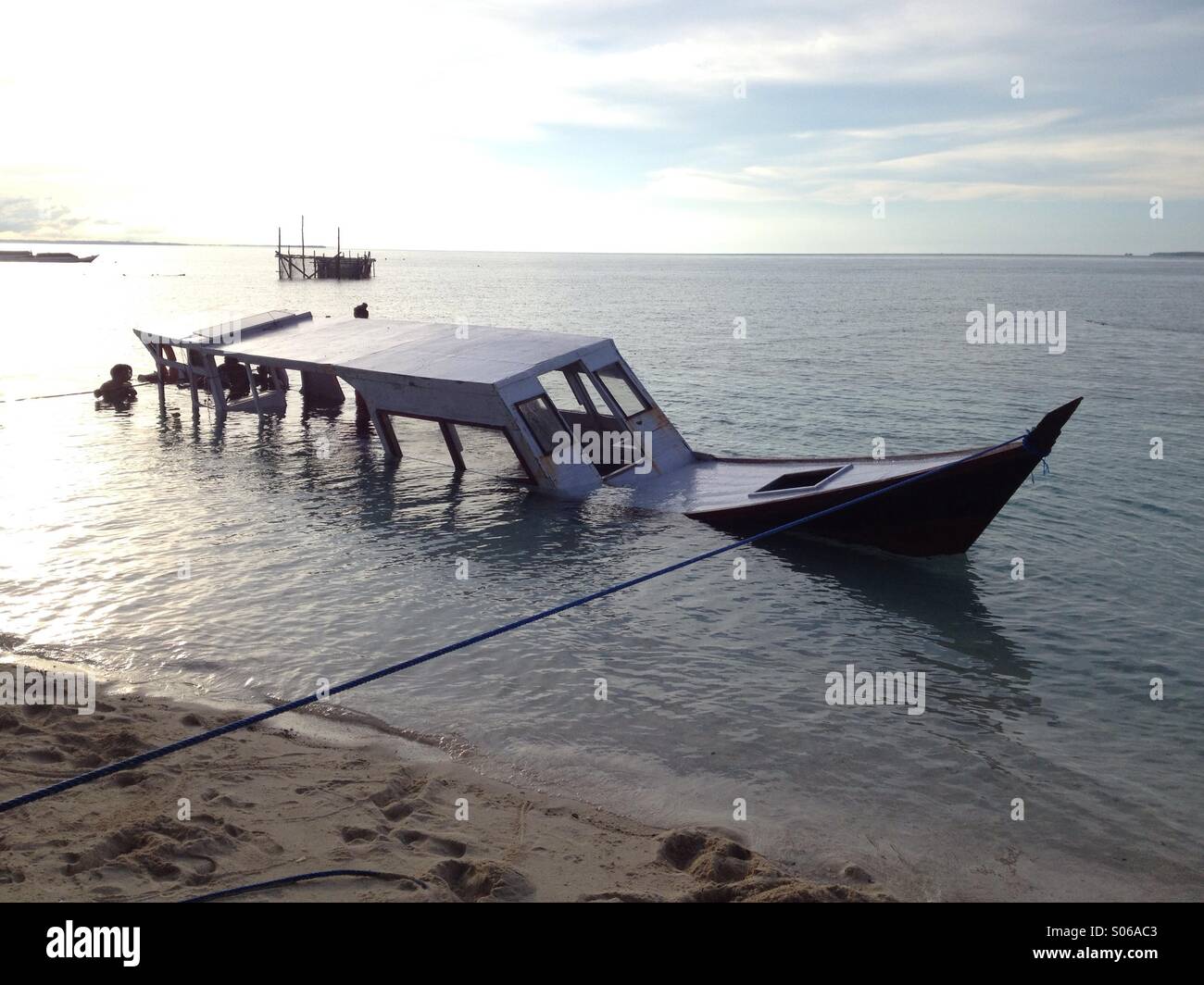 Abouttosink boat during high tide Stock Photo Alamy