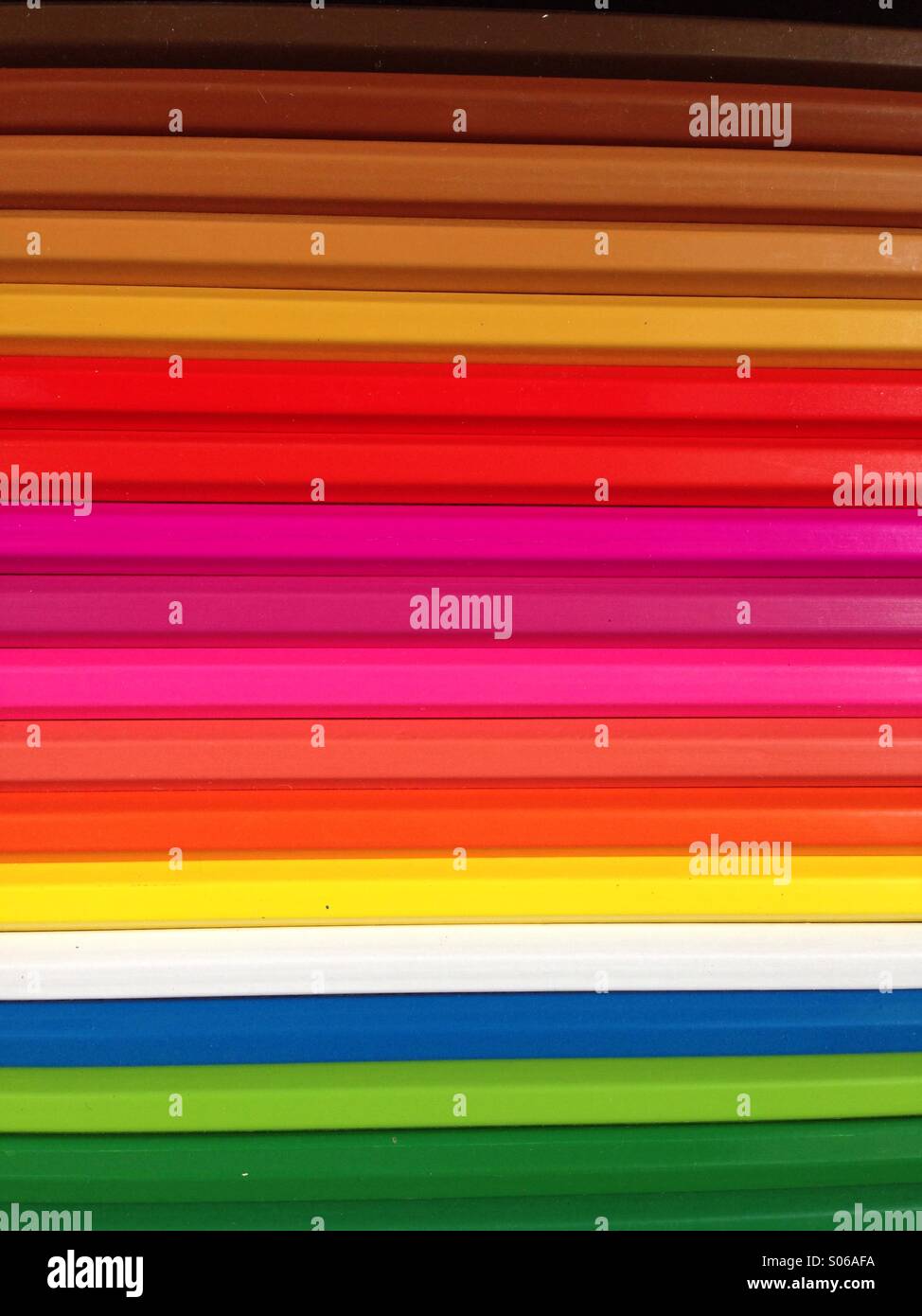 Coloured pencils lined up to make colourful stripes. - Smartphone Captured Stock Image
