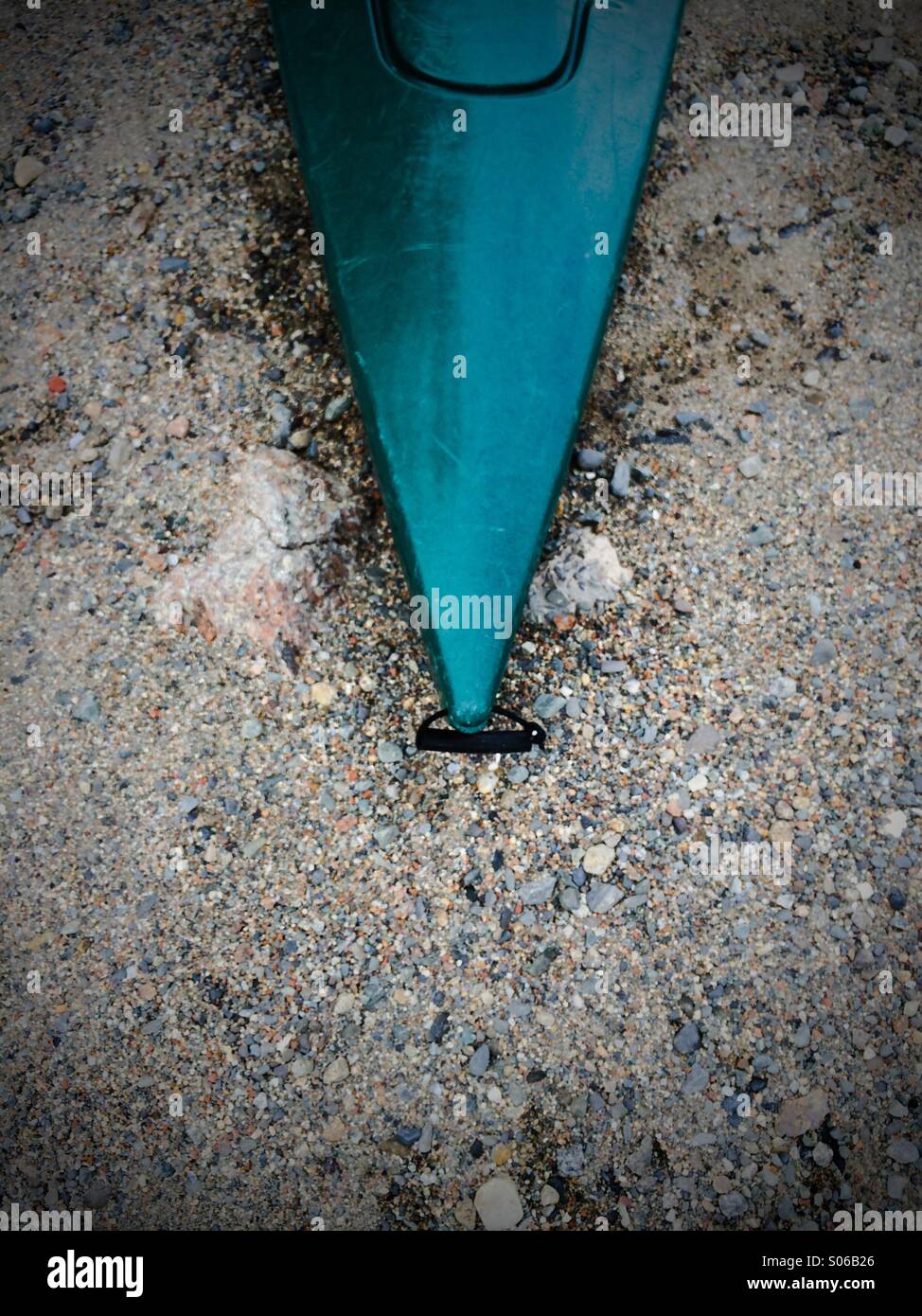 Green bow of kayak on beach Stock Photo