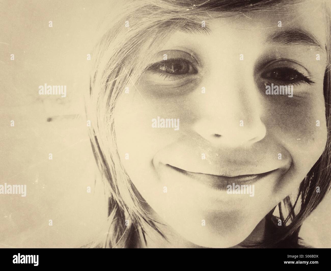 Caucasian boy smiling. Sepia vintage toning. - Smartphone Captured Stock Image