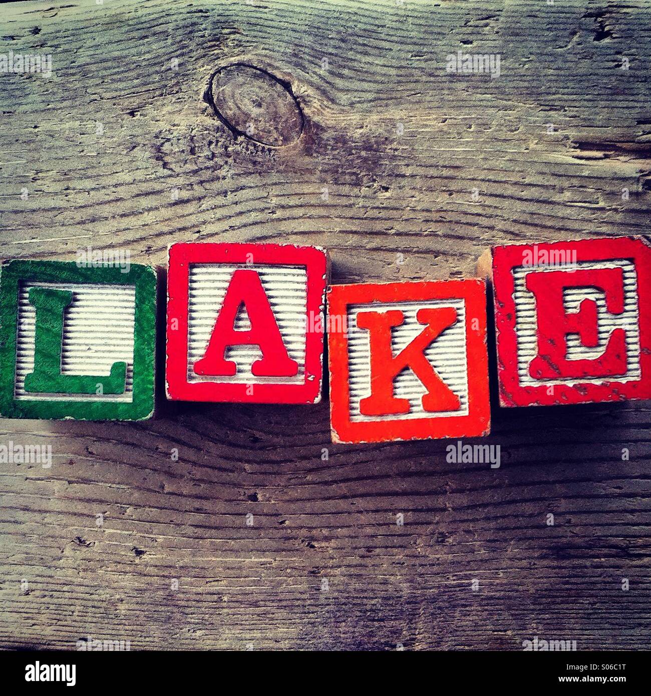 It's a photo of Woodblocks toy games with alphabet letters on them wich combine together to form the word LAKE - Smartphone Captured Stock Image