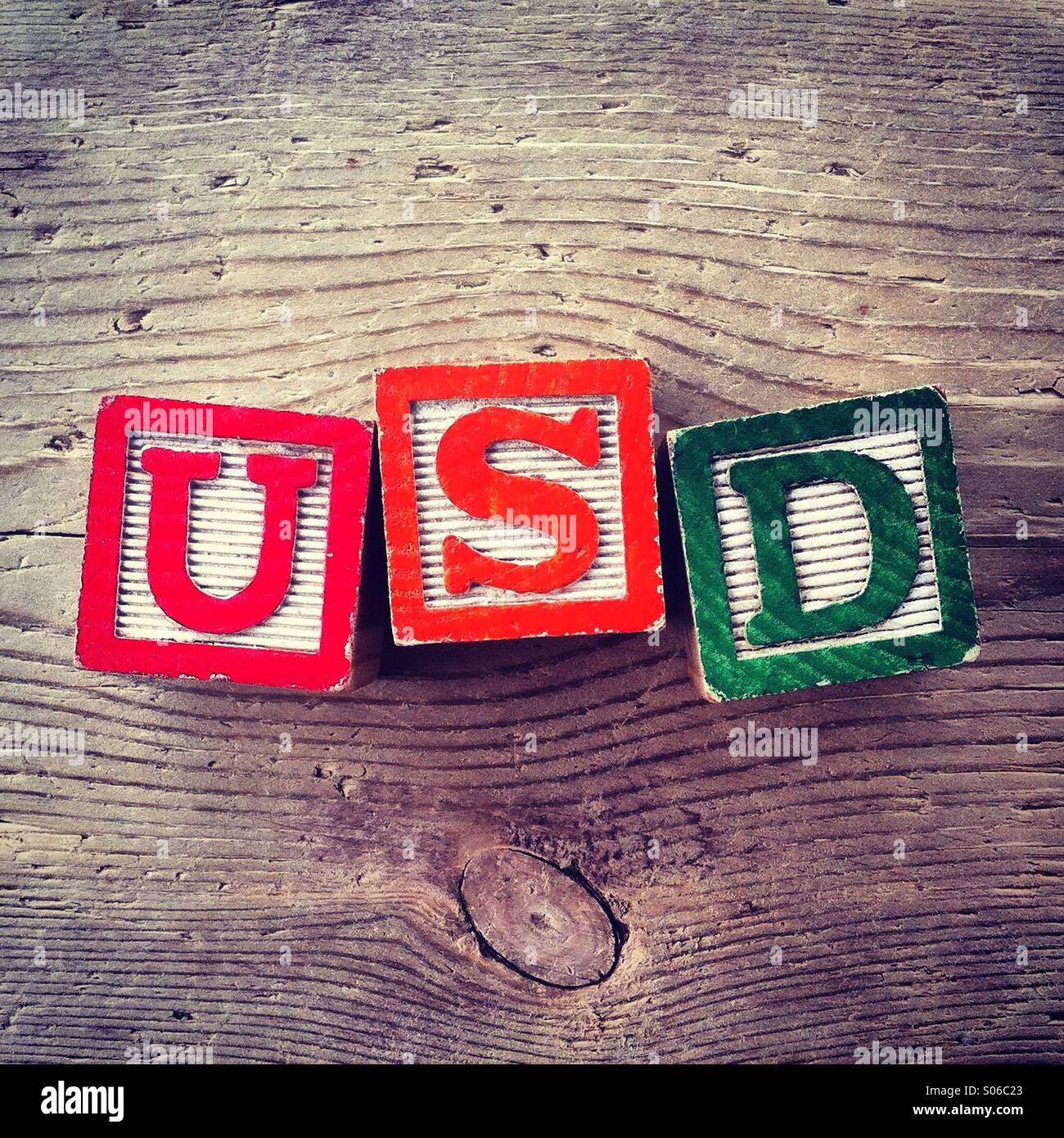 It's a photo of Woodblocks toy games with alphabet letters on them wich combine together to form the acronym USD for United States Dollar - Smartphone Captured Stock Image