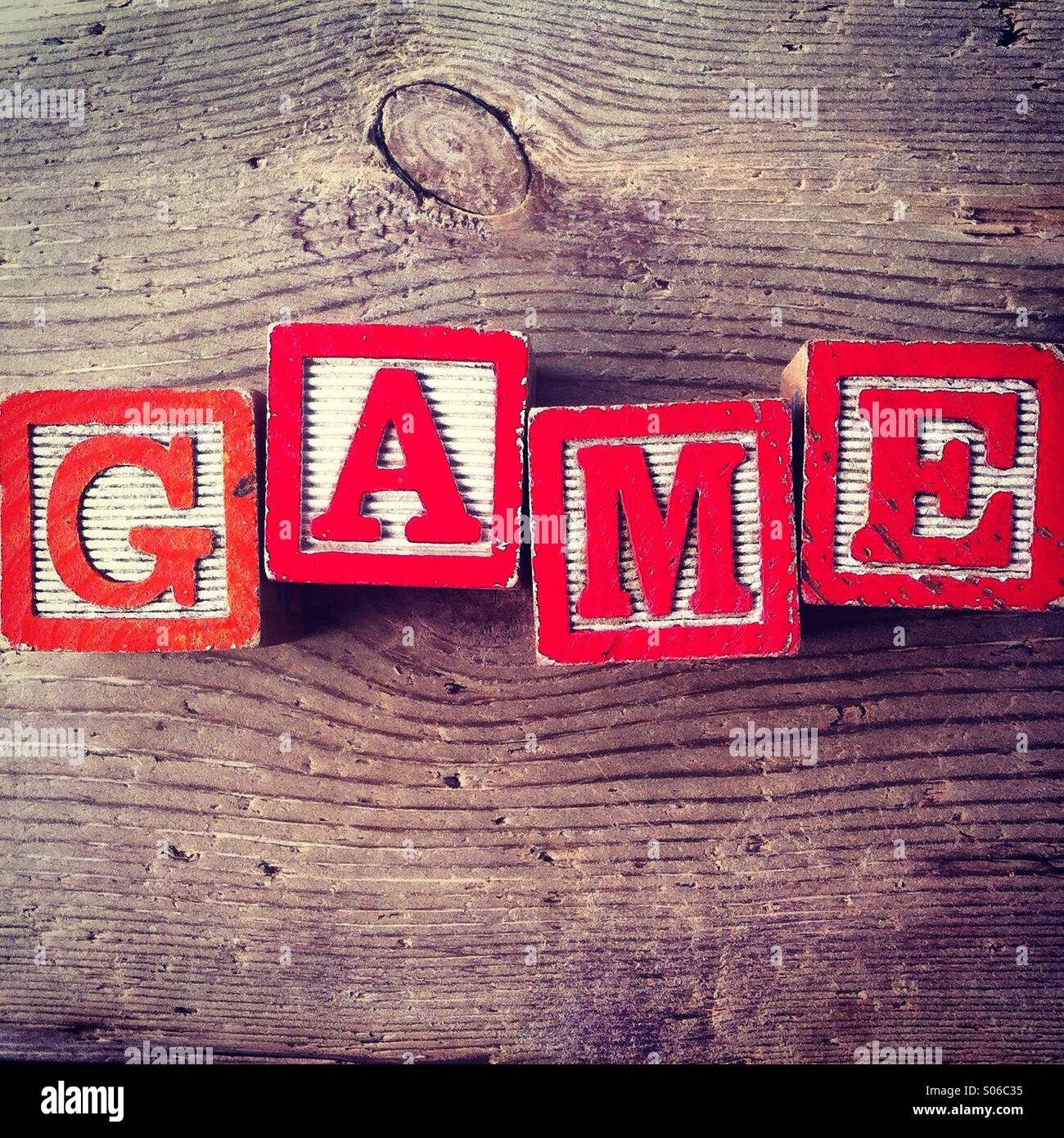 It's a photo of Woodblocks toy games with alphabet letters on them wich combine together to form the word GAME - Smartphone Captured Stock Image