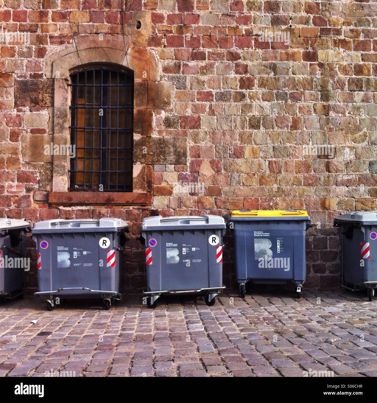 Trash bins by the brick wall at the Montjuic Castle, Barcelona, Catalunya, Spain, 2014. - Smartphone Captured Stock Image