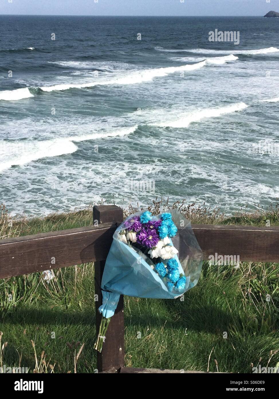 Flowers left in memory of a loved one. - Smartphone Captured Stock Image