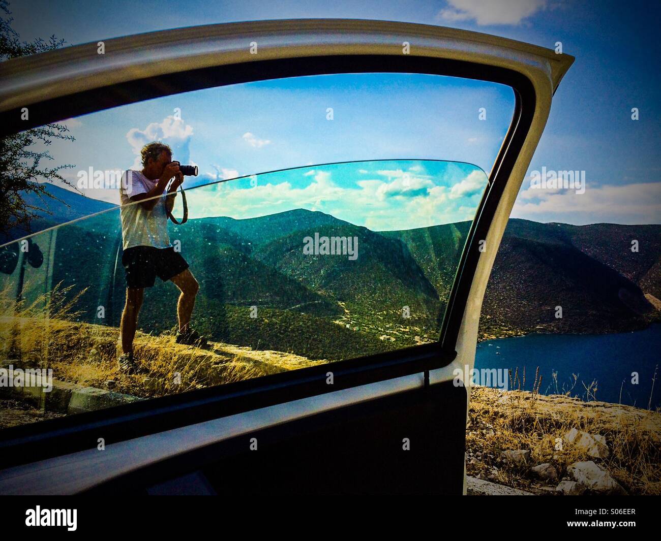 Photographer taking a landscape photo in Evia Island Greece Stock Photo