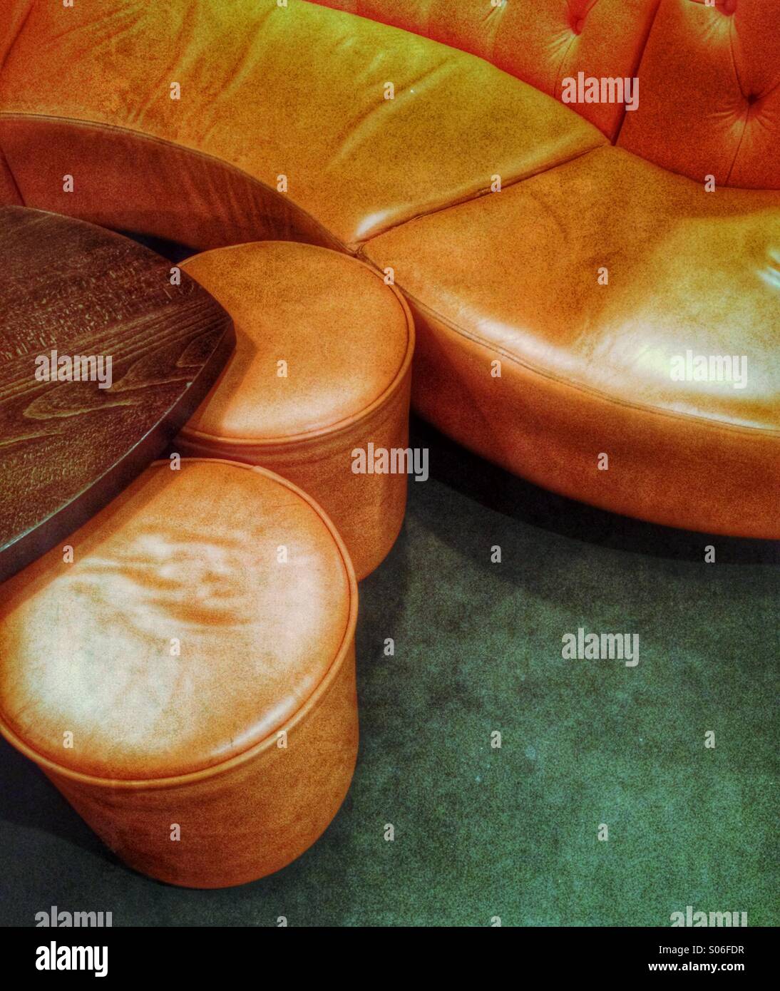 A leather sofa and foot stools Stock Photo