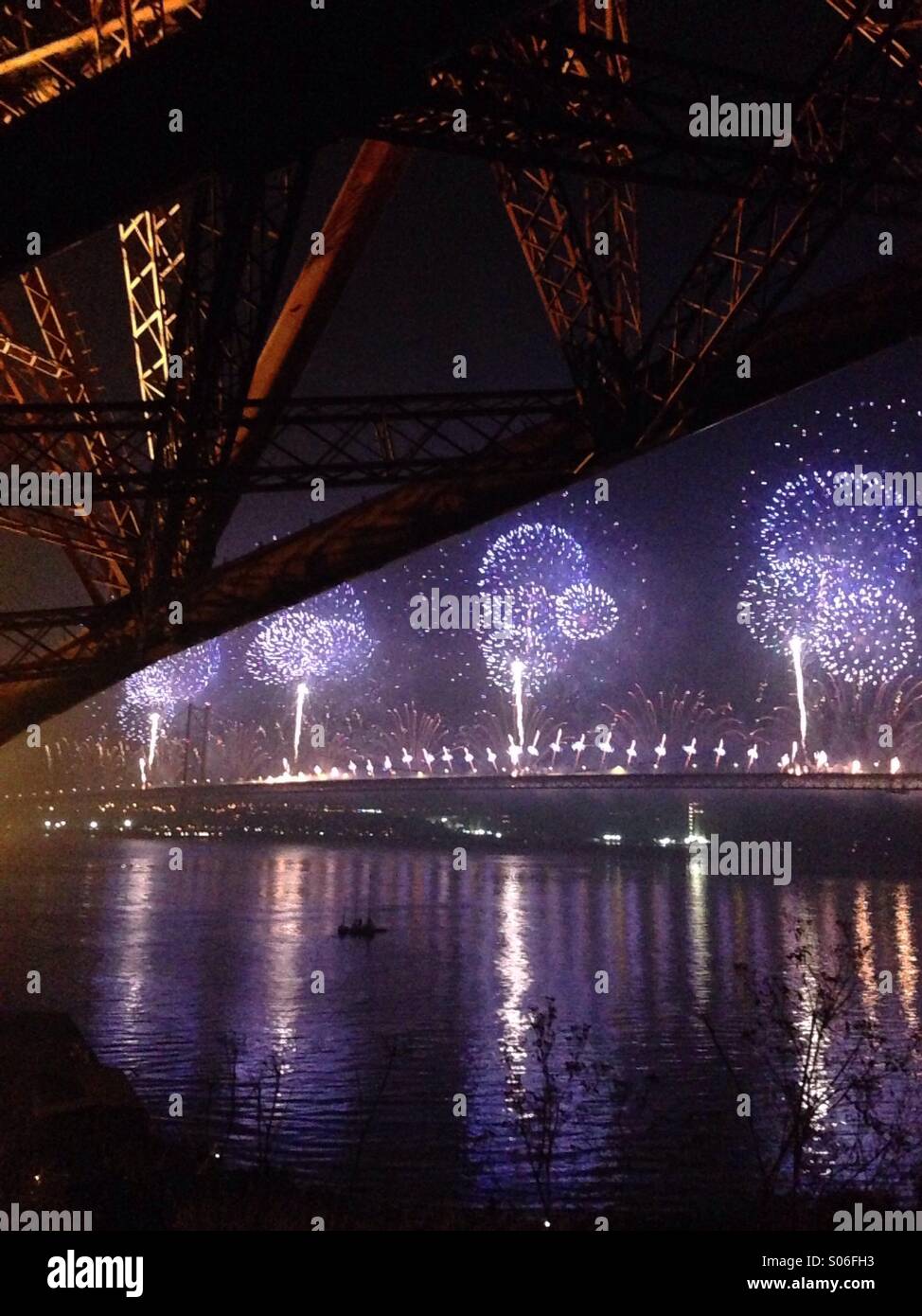 Forth Bridge Festival fireworks celebrating 50 years of the Forth Road Bridge, with the Forth rail Bridge in the foreground. - Smartphone Captured Stock Image