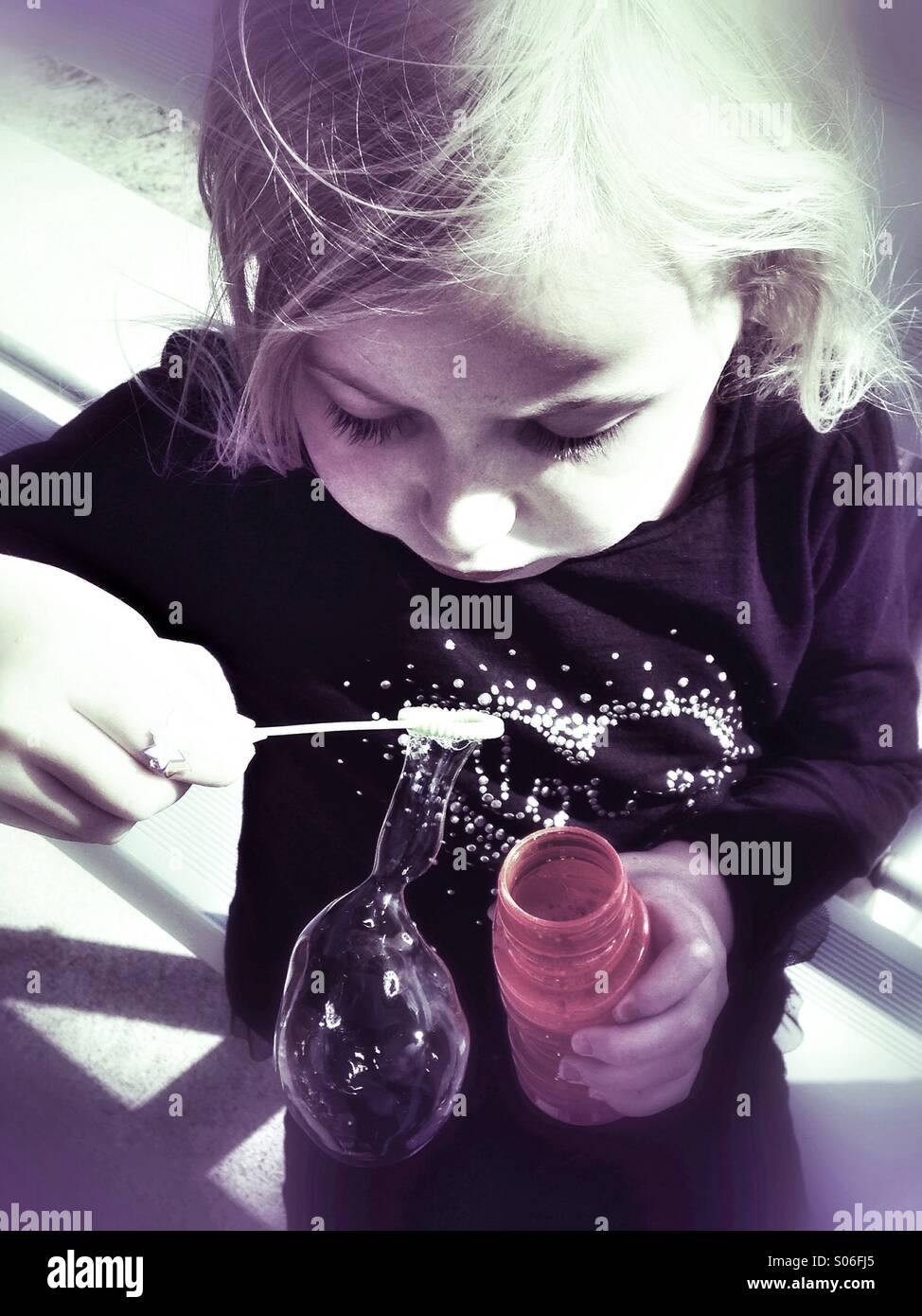 Bubble blowing girl. Stock Photo