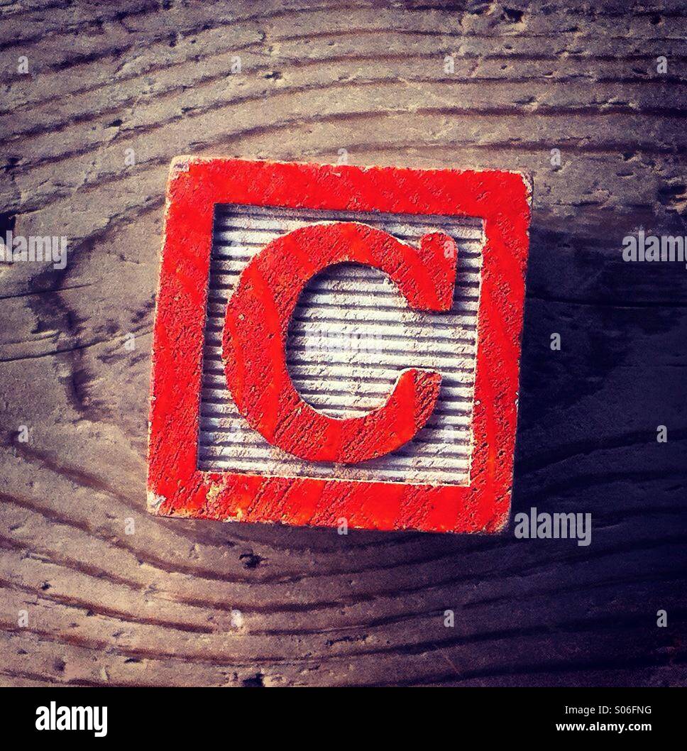It's a woodblock toy with an alphabet letter on it: C - Smartphone Captured Stock Image
