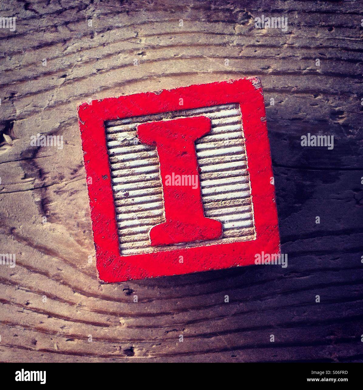 It's a woodblock toy with an alphabet letter on it: I - Smartphone Captured Stock Image