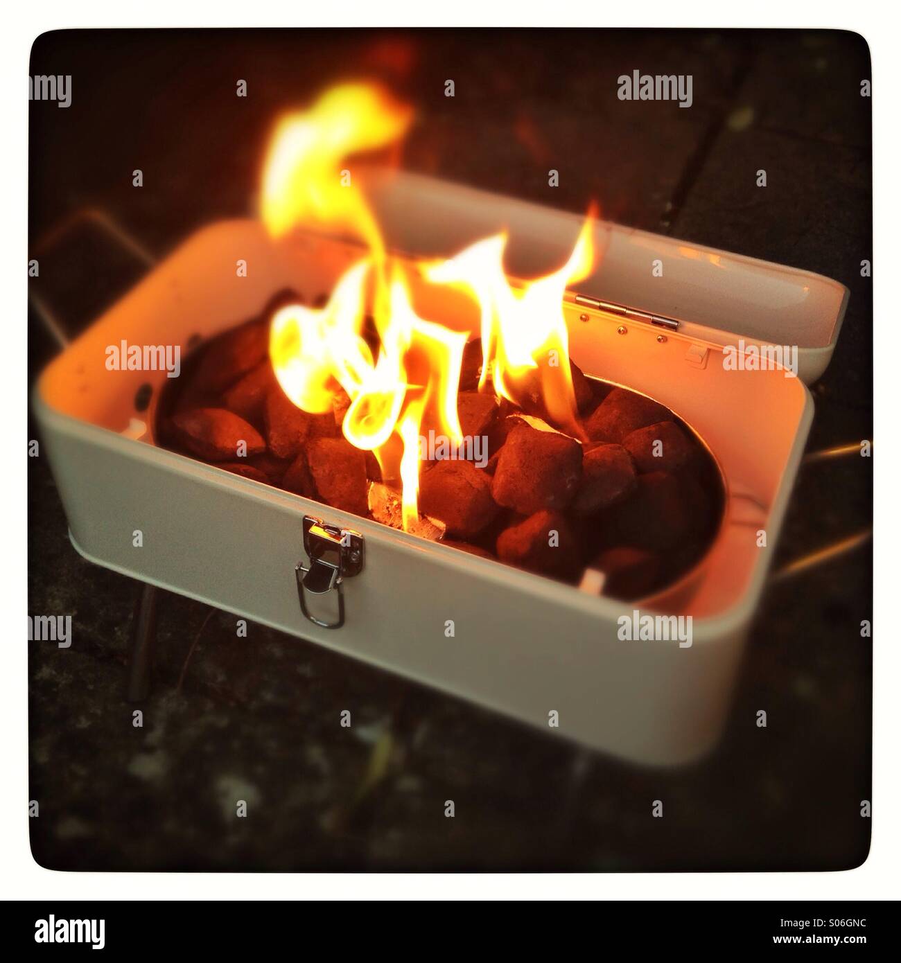 Lighting a Portable Mini barbecue Stock Photo