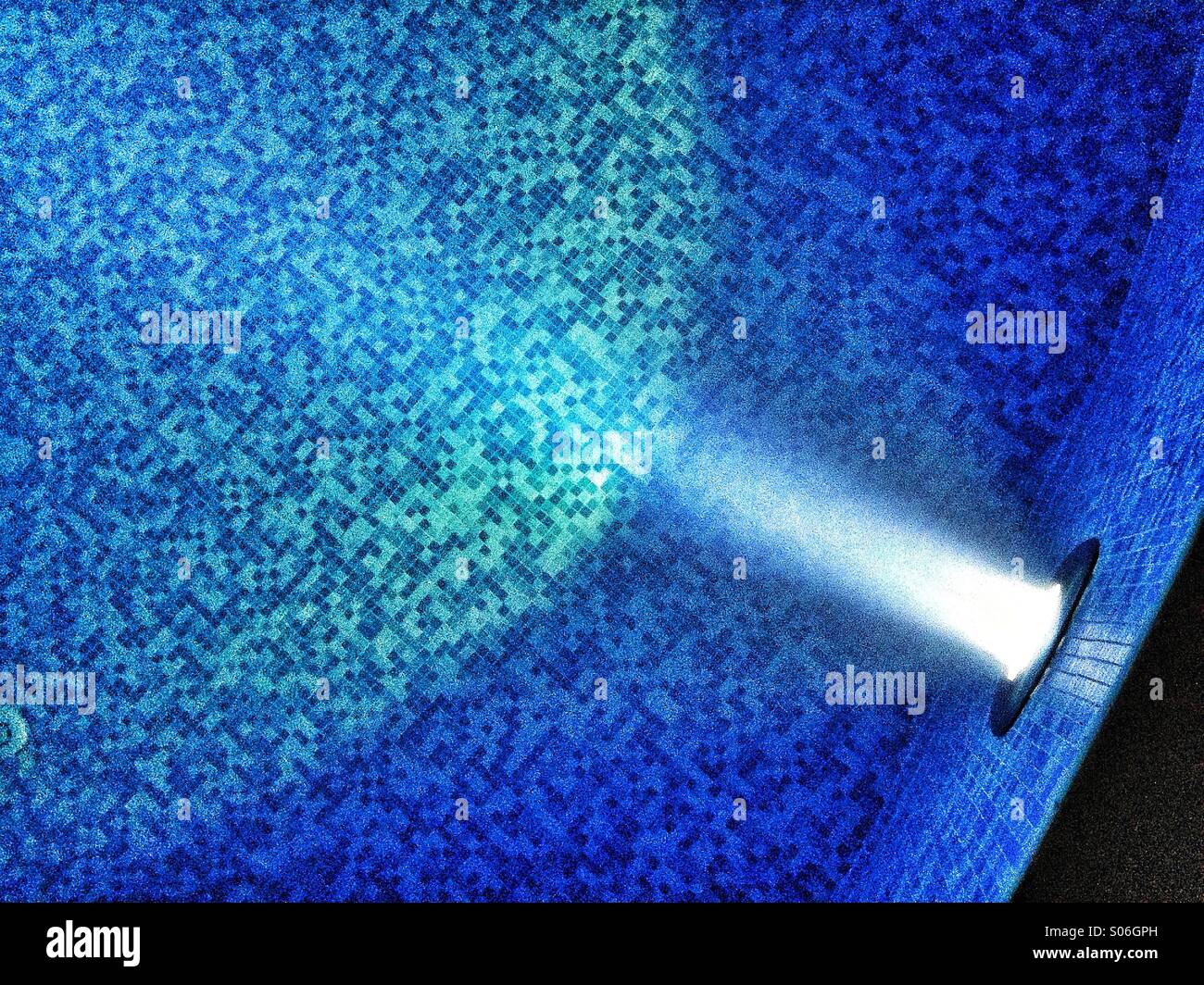 Underwater Beam of Light Shining onto the Blue Mosaics of a Swimming Pool Floor. Photo Credit - © COLIN HOSKINS. - Smartphone Captured Stock Image