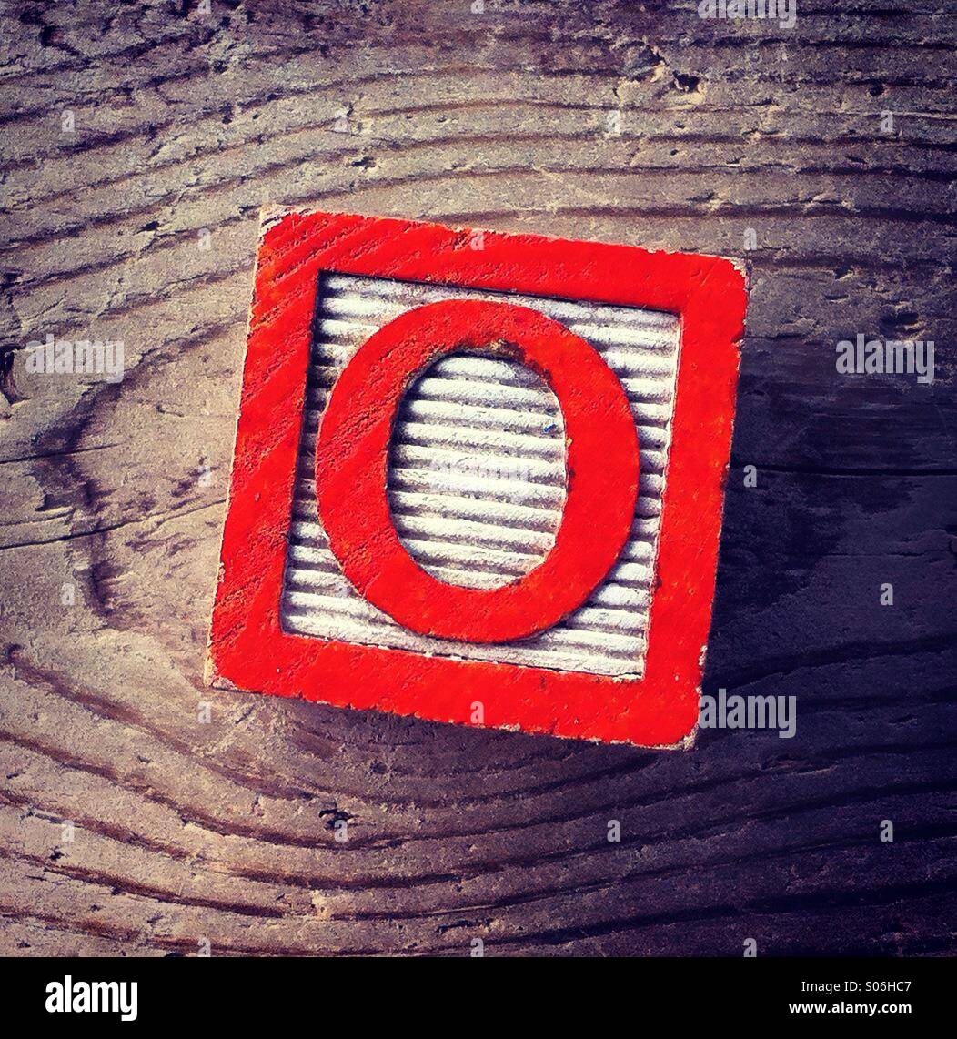 It's a woodblock toy with an alphabet letter on it: Q Stock Photo