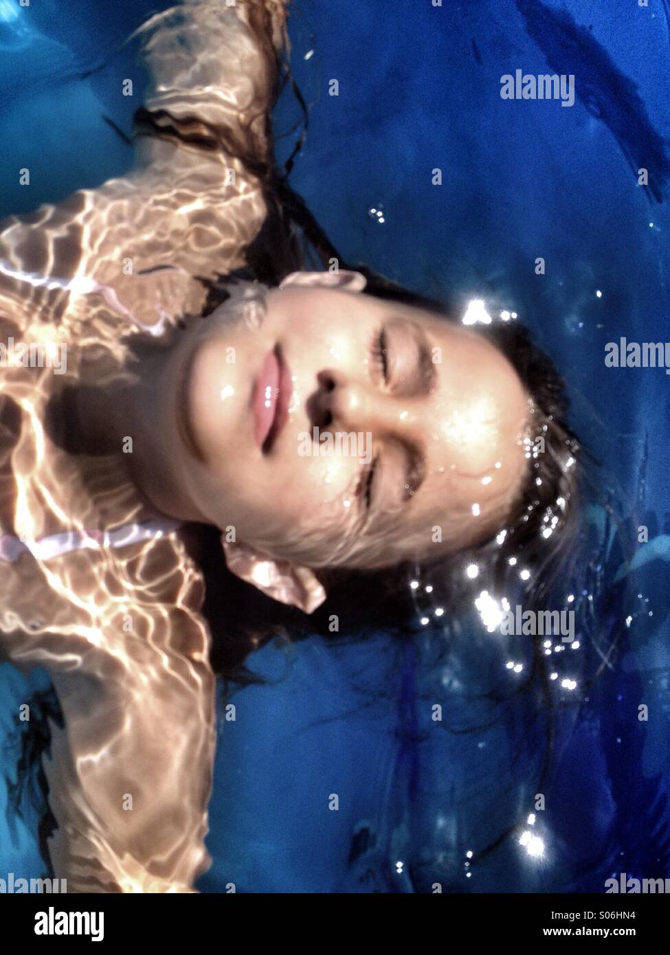 Girl floating in water Stock Photo Alamy