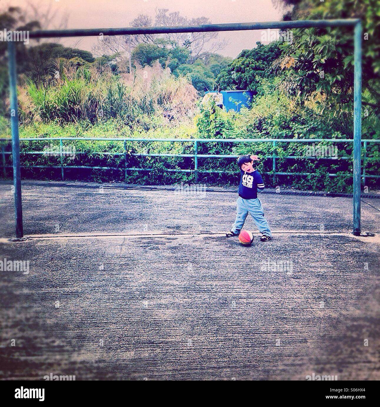 It's a photo of a small kid goal keeper on a kid's playgroung - Smartphone Captured Stock Image