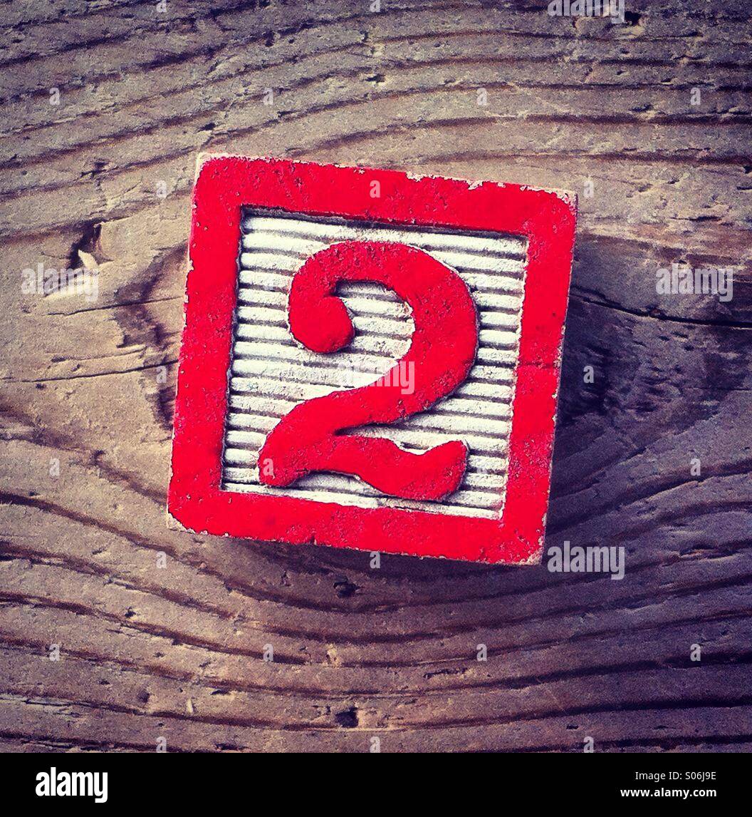 It's a photo of a woodblock toy with a number on it : 2 Stock Photo