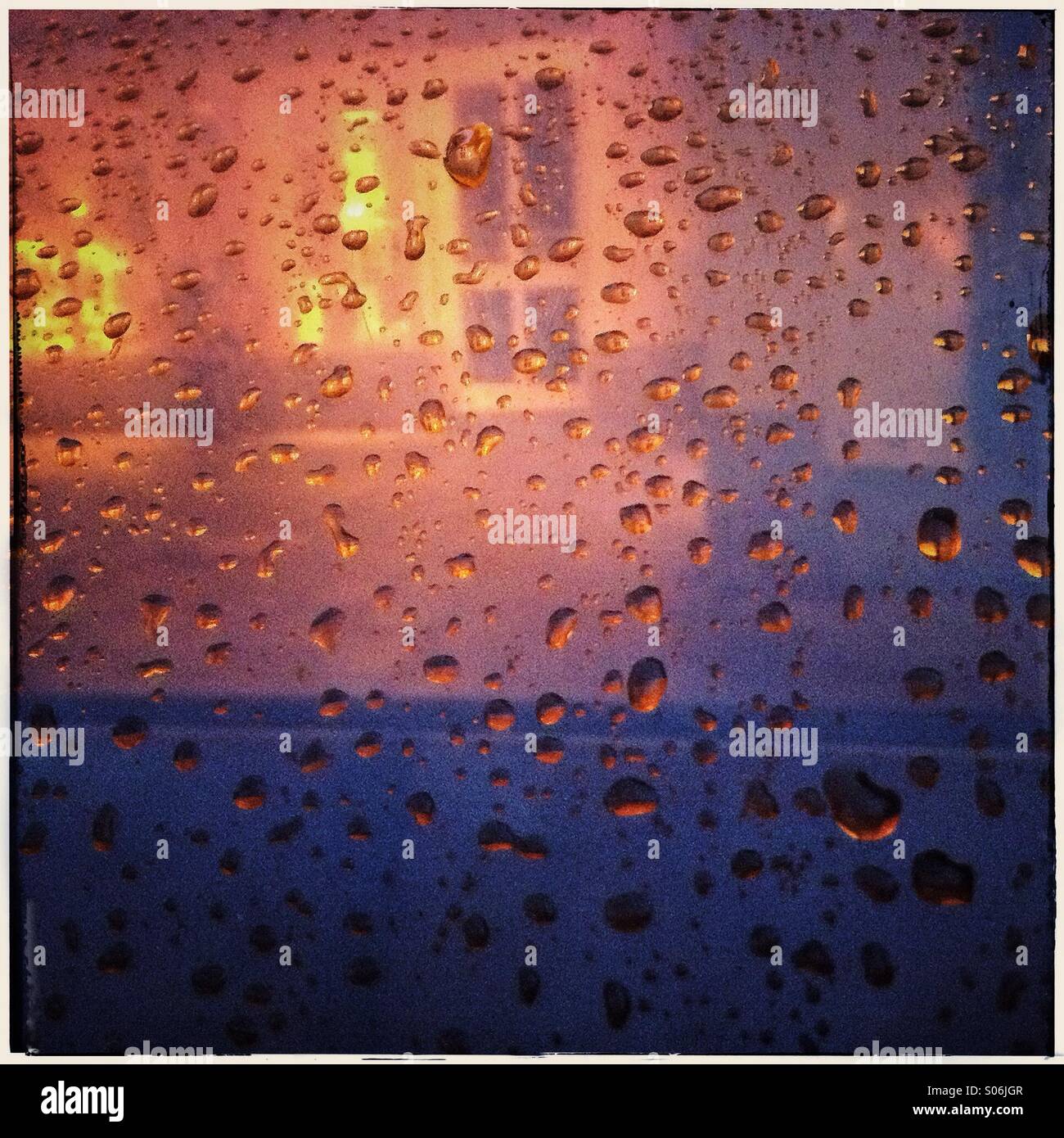House's window seen through car window and rain drops. Garmisch Partenkirchen, Bavaria, Germany, Europe Stock Photo