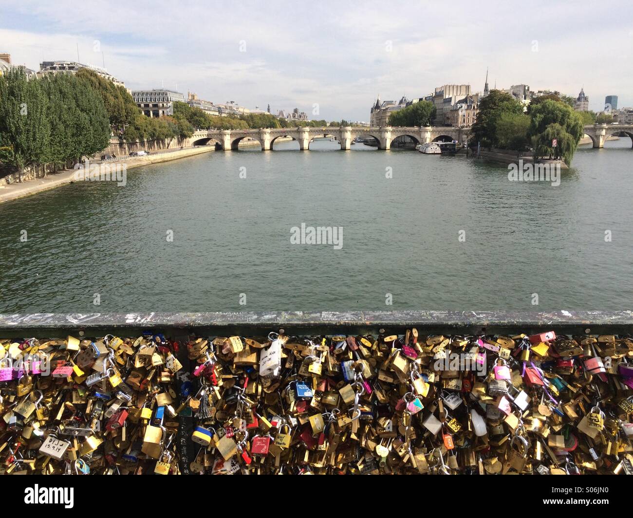 Romantics place locks on a bridge in Paris - Smartphone Captured Stock Image