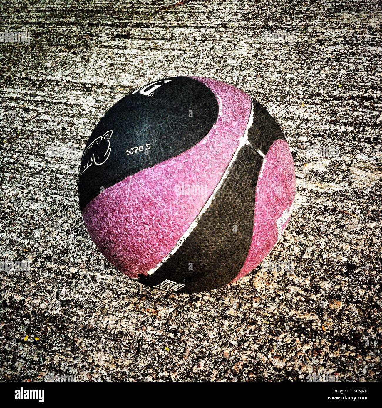 It's a basketball vall on a cpncrete floor of a kid's plaground - Smartphone Captured Stock Image