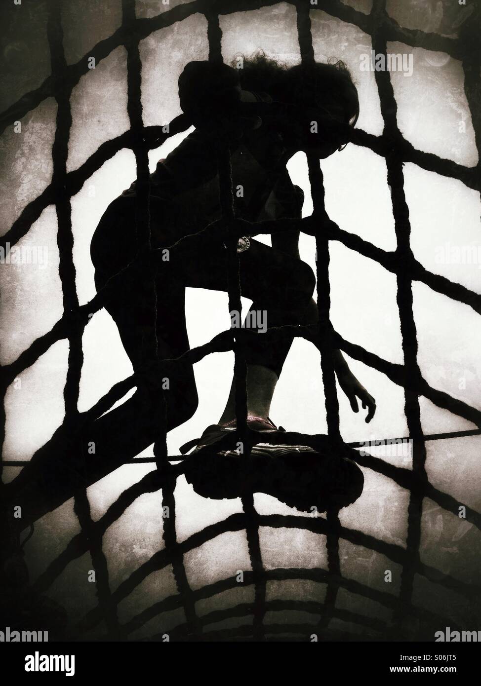 Girl climbing on rope net Stock Photo Alamy