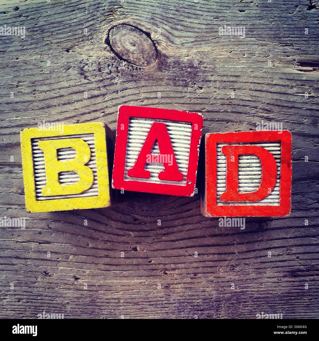 It's a photo of woodblocks toys will alphabet letter on them which are combines together to create the word BAD - Smartphone Captured Stock Image
