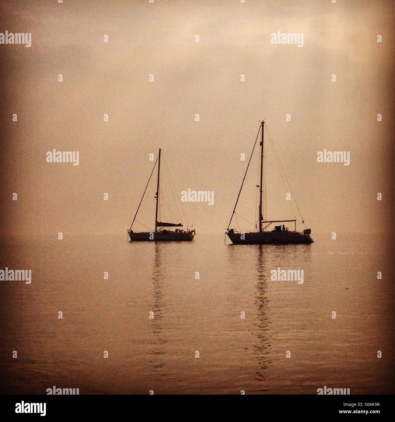 Yachts moored on misty estuary - Smartphone Captured Stock Image