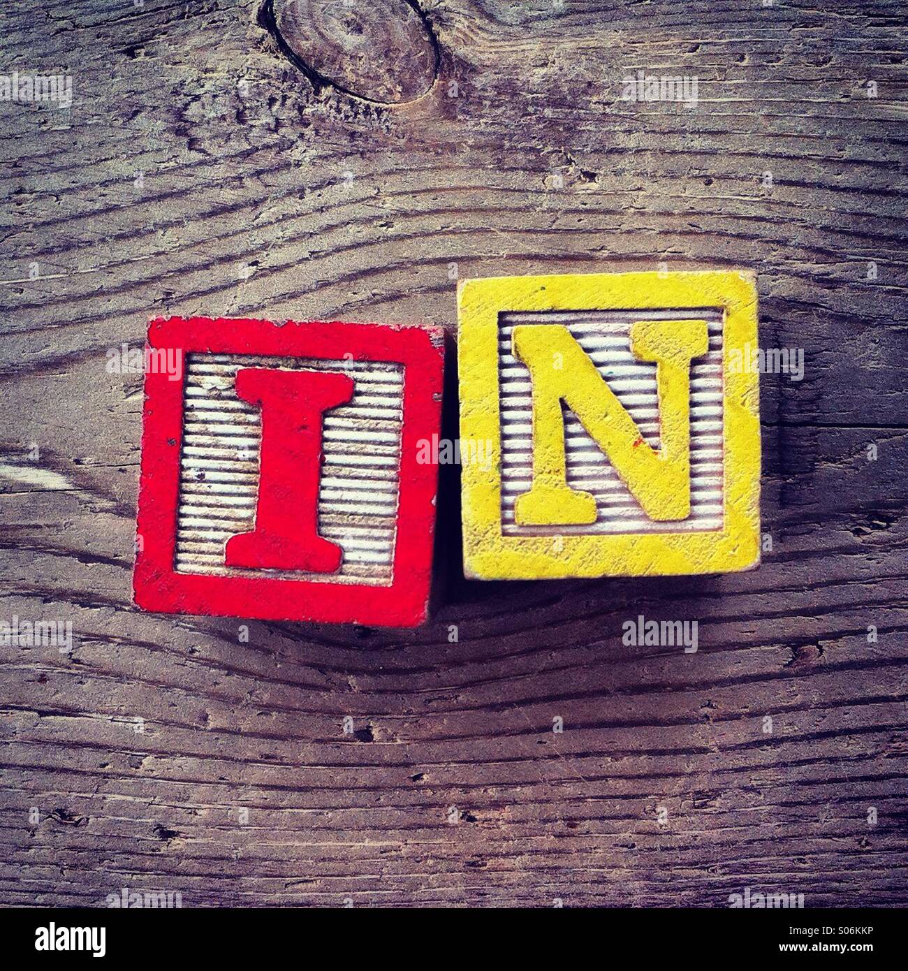 It's a photo of woodblocks toys will alphabet letter on them which are combines together to create the word IN - Smartphone Captured Stock Image