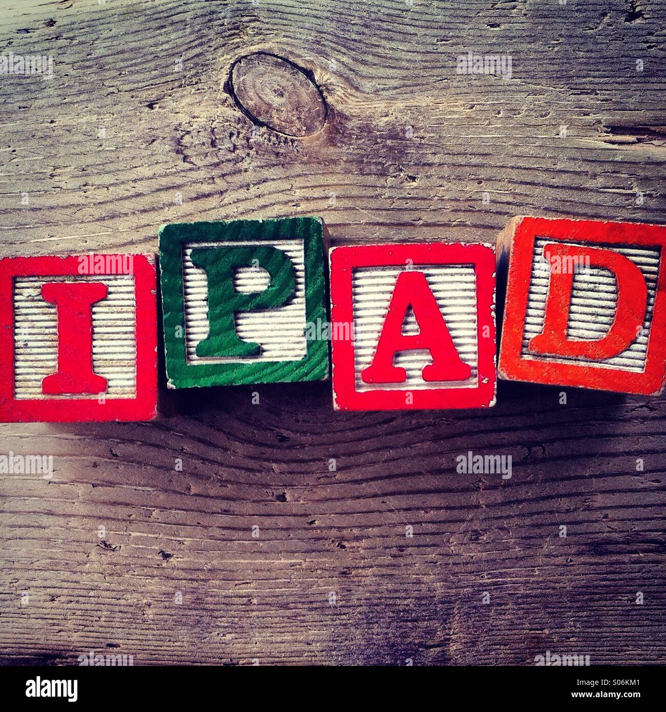 It's a photo of woodblocks toys will alphabet letter on them which are combines together to create the word IPAD - Smartphone Captured Stock Image