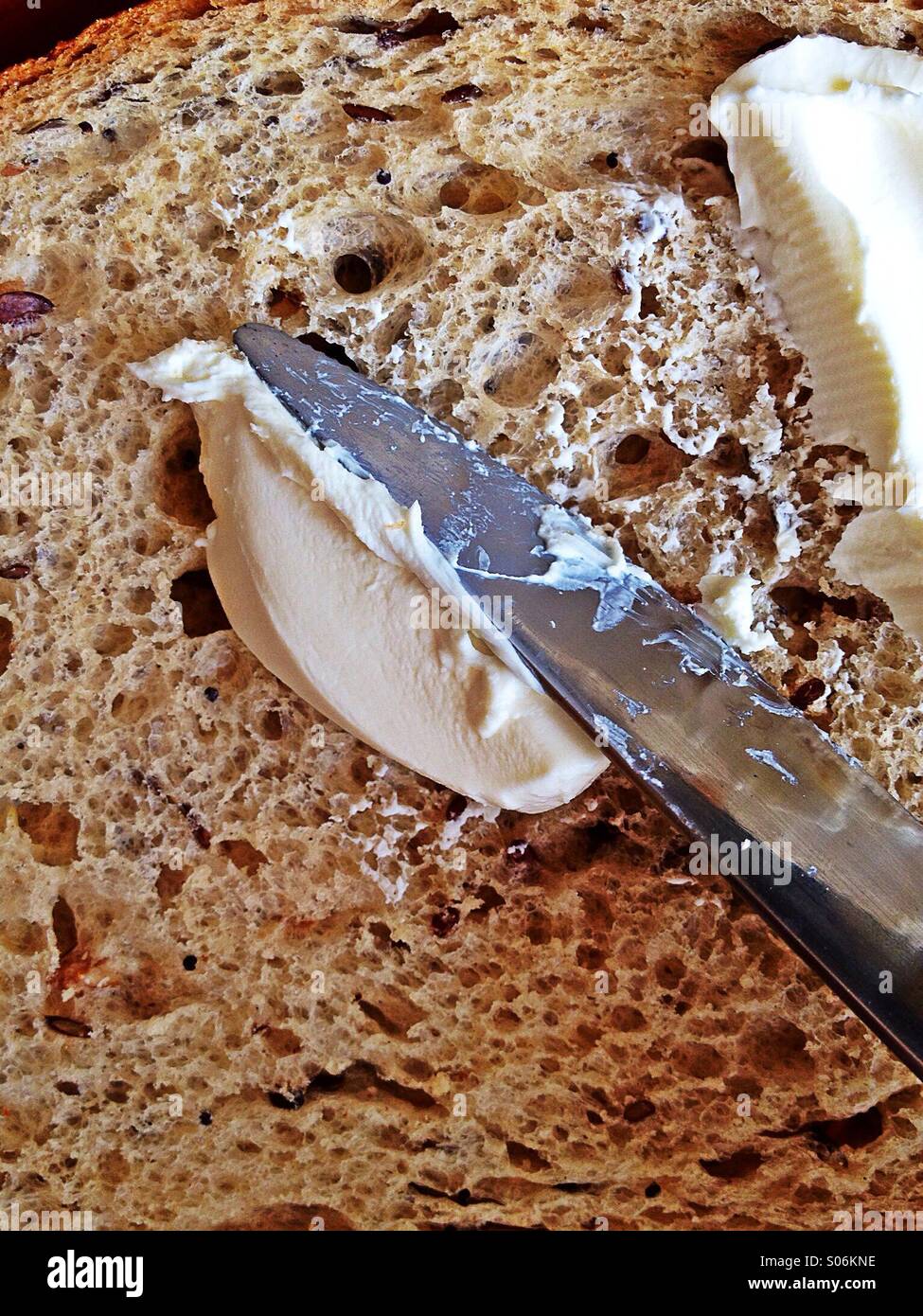 Spreading cream cheese on bread - Smartphone Captured Stock Image