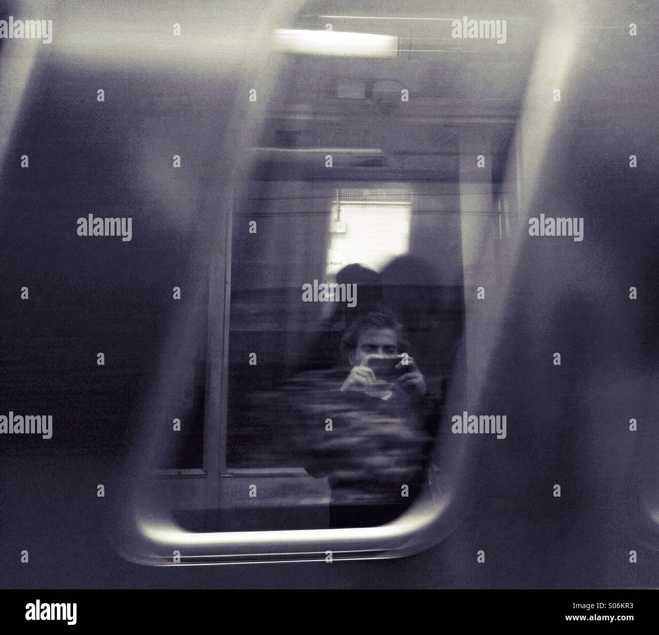 Urban reflection on a train window - Smartphone Captured Stock Image