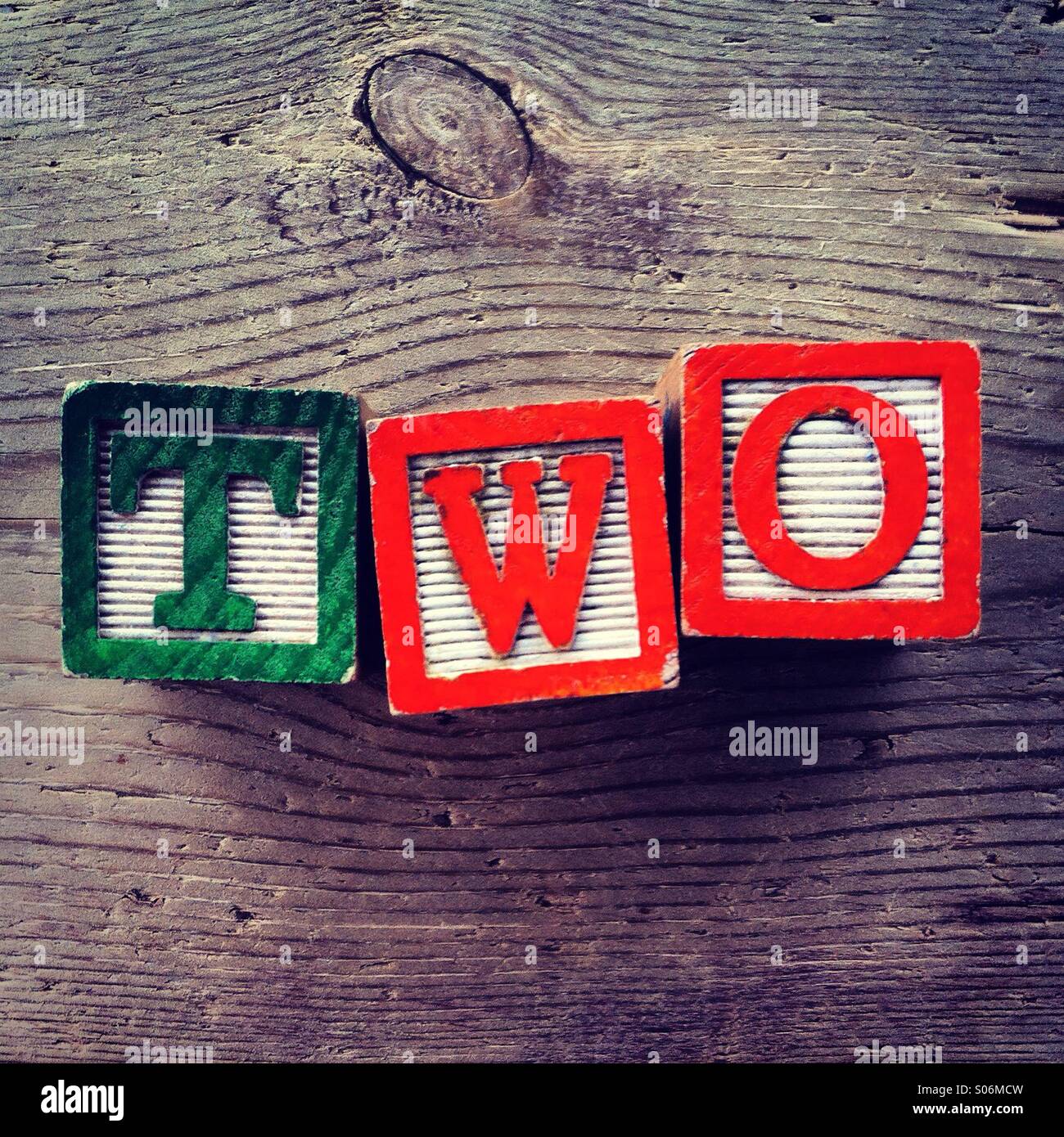 It's a photo of woodblocks toys will alphabet letter on them which are combines together to create the word TWO - Smartphone Captured Stock Image