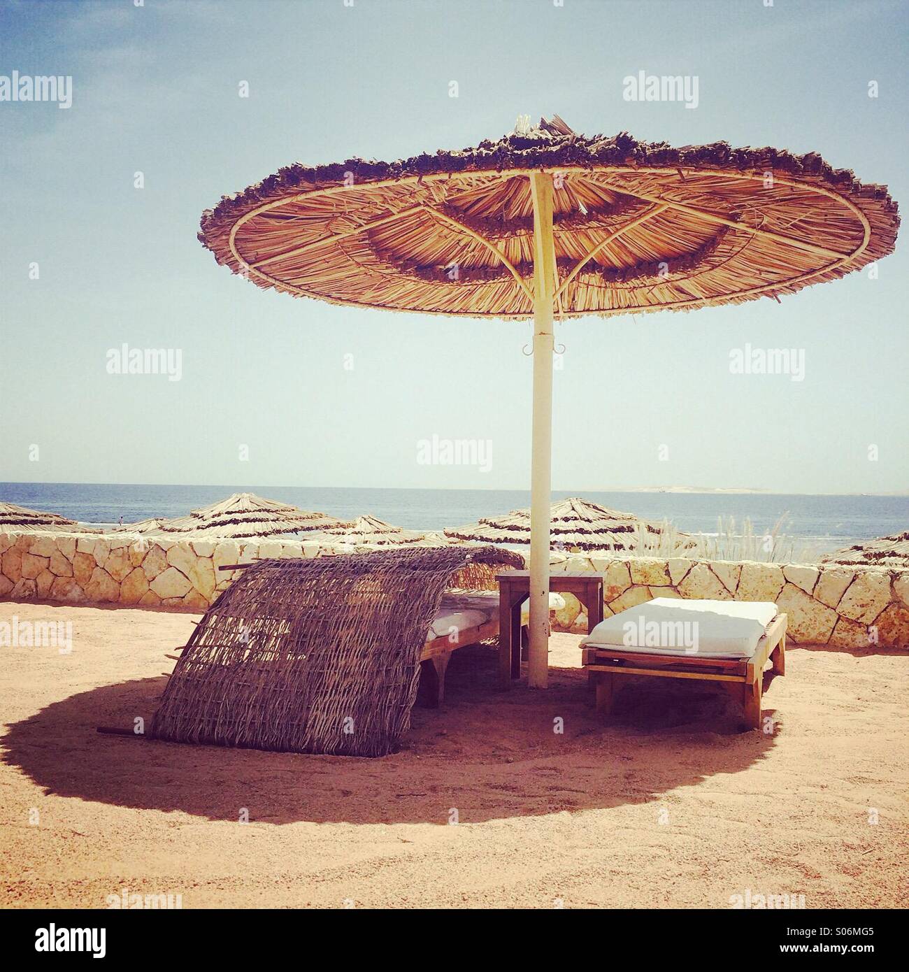 Sun lounger and umbrella in a holiday resort in Egypt with a retro filter  applied Stock Photo - Alamy
