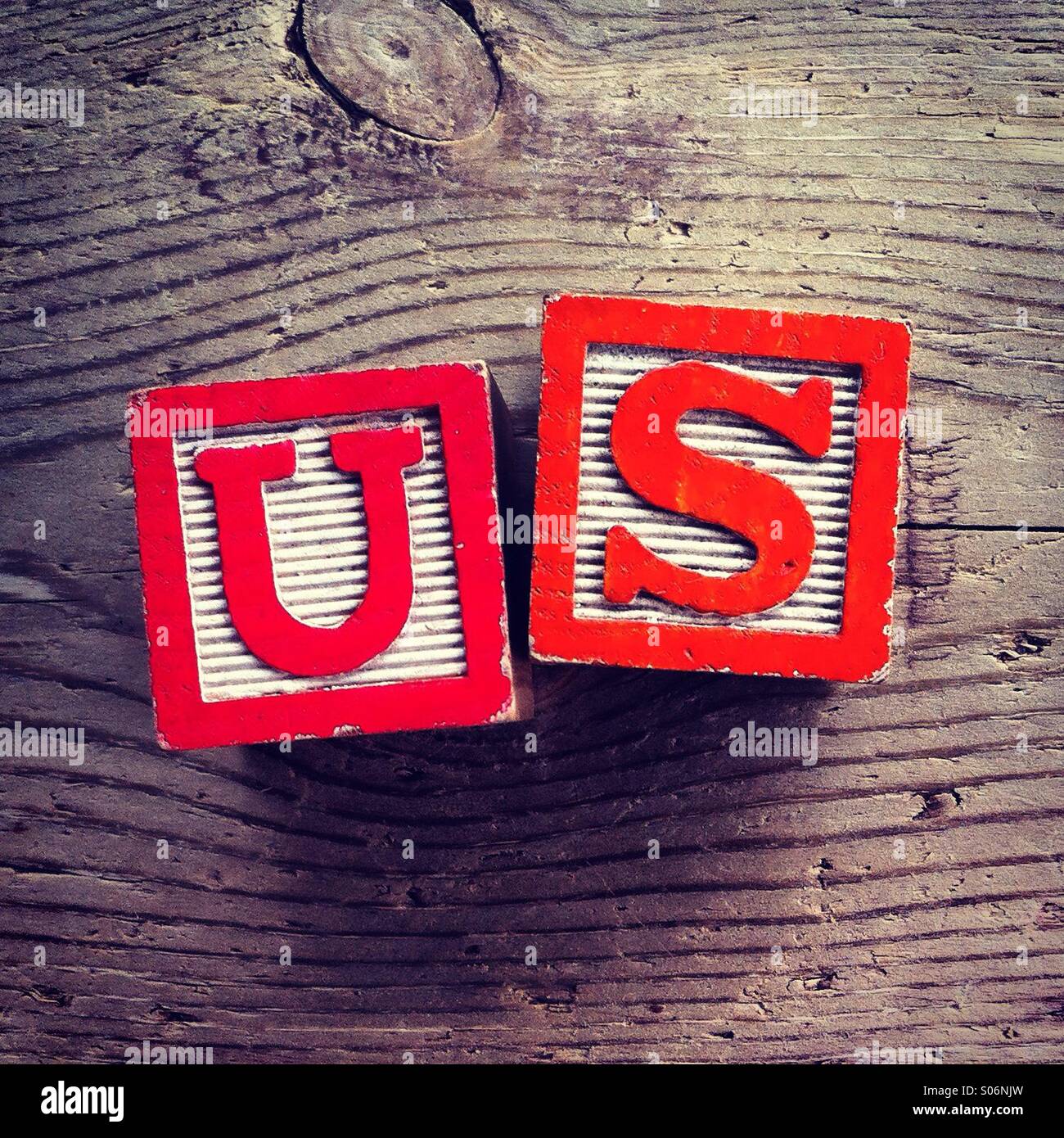 It's a photo of woodblocks toys will alphabet letter on them which are combines together to create the word US - Smartphone Captured Stock Image