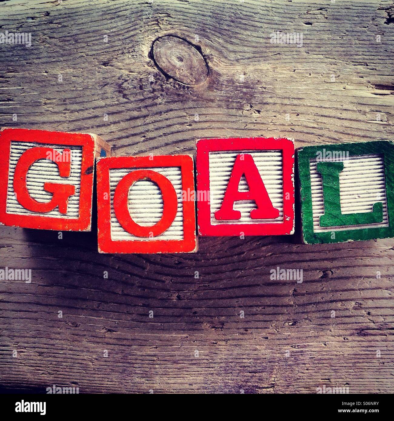 It's a photo of woodblocks toys will alphabet letter on them which are combines together to create the word GOAL - Smartphone Captured Stock Image