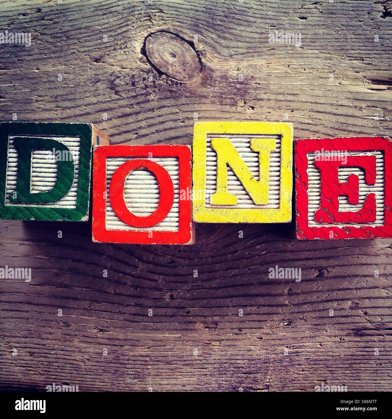 It's a photo of woodblocks toys will alphabet letter on them which are combines together to create the word DONE - Smartphone Captured Stock Image