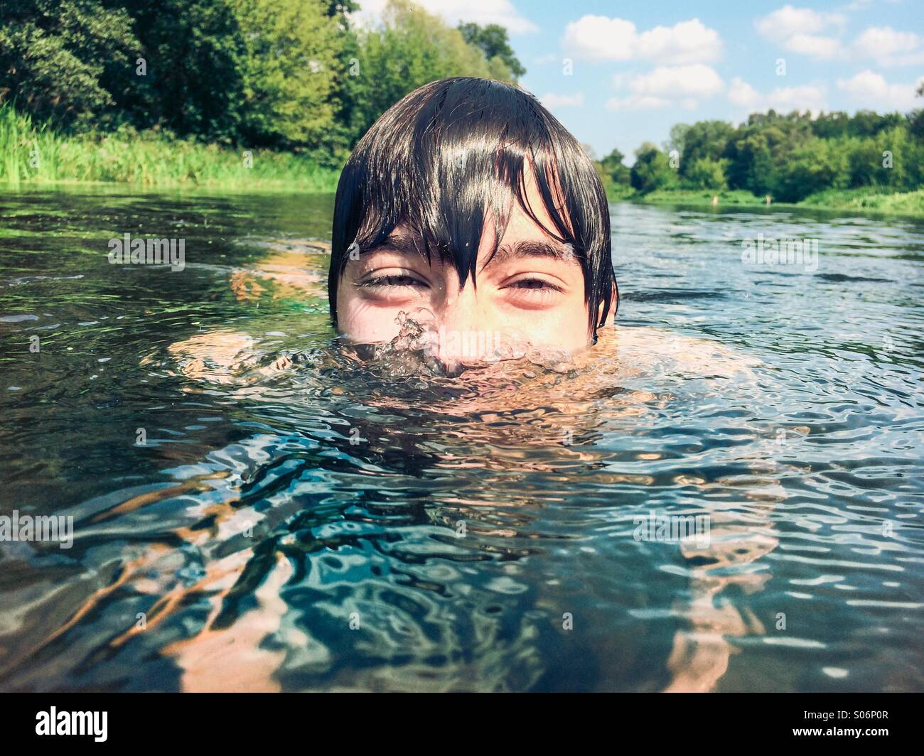Young boy swimming in river hires stock photography and images Alamy