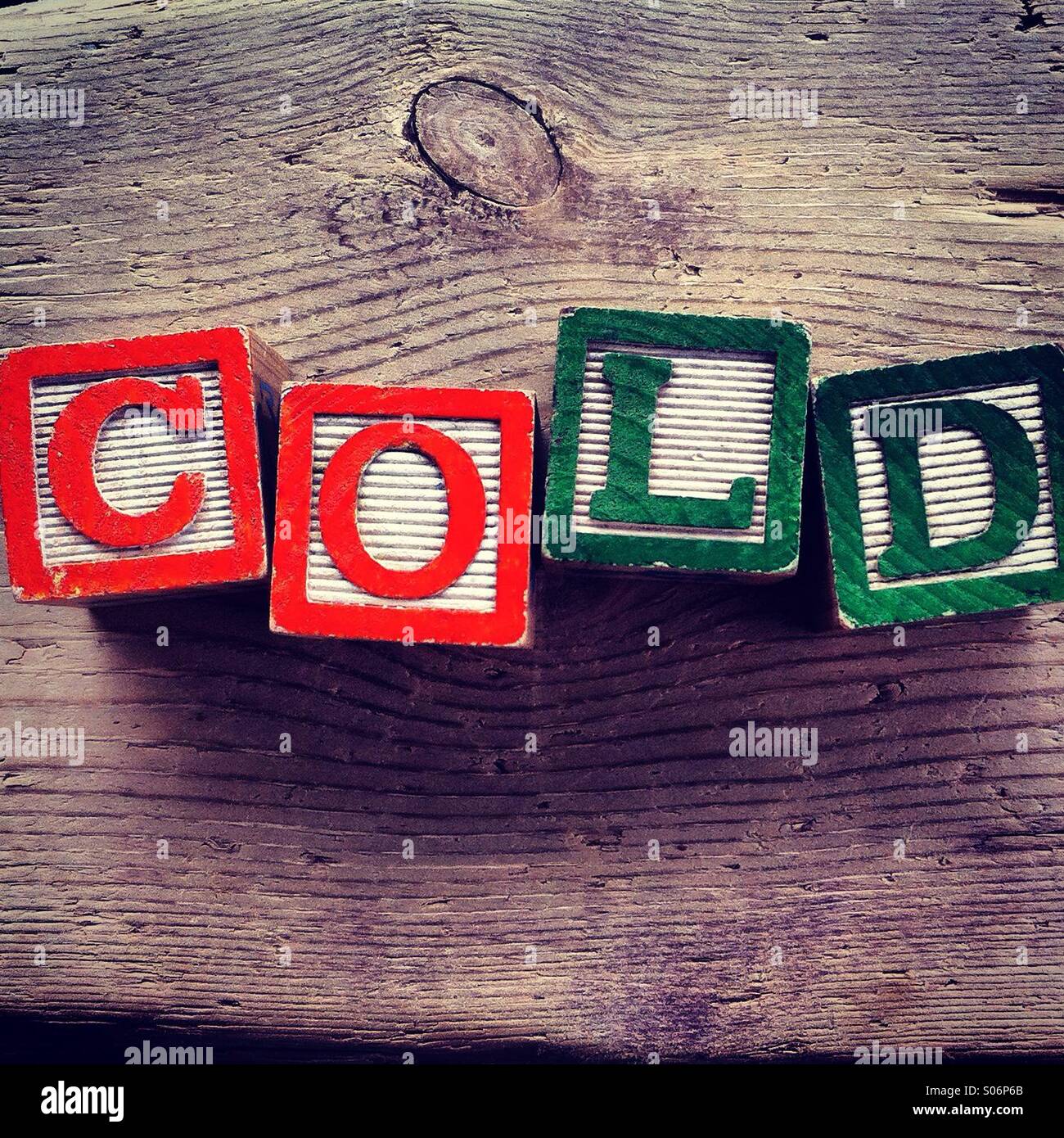 It's a photo of woodblocks toys will alphabet letter on them which are combines together to create the word COLD - Smartphone Captured Stock Image