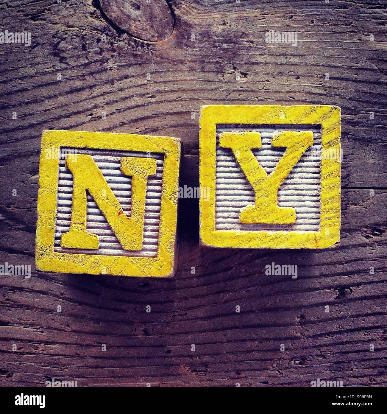 It's a photo of woodblocks toys will alphabet letter on them which are combines together to create the acronym NY - Smartphone Captured Stock Image