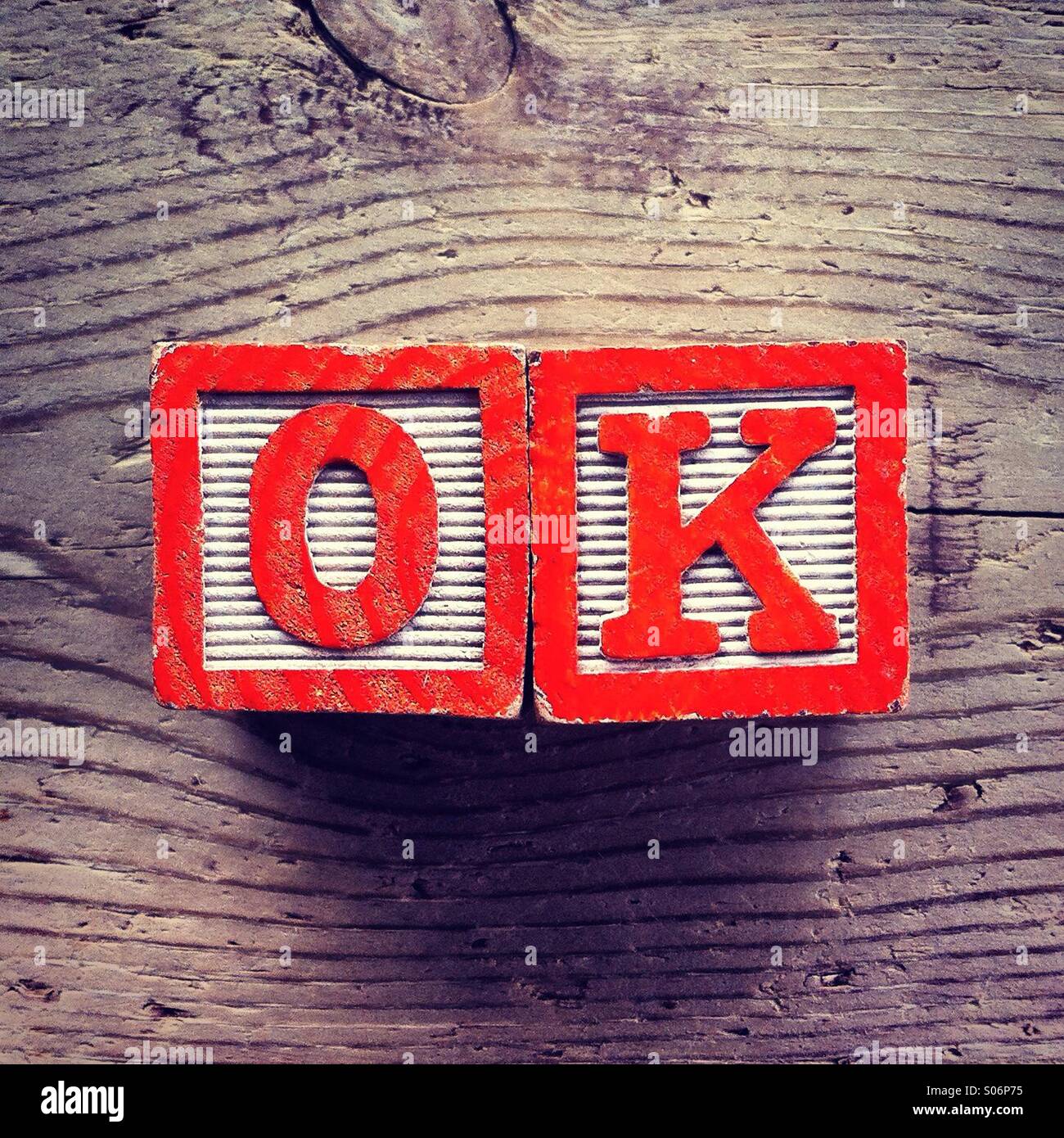 It's a photo of woodblocks toys will alphabet letter on them which are combines together to create the acronym OK - Smartphone Captured Stock Image