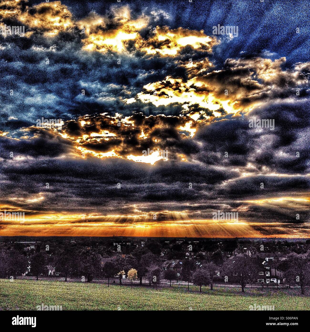 Urban sunsets over South West london as seen from park Stock Photo