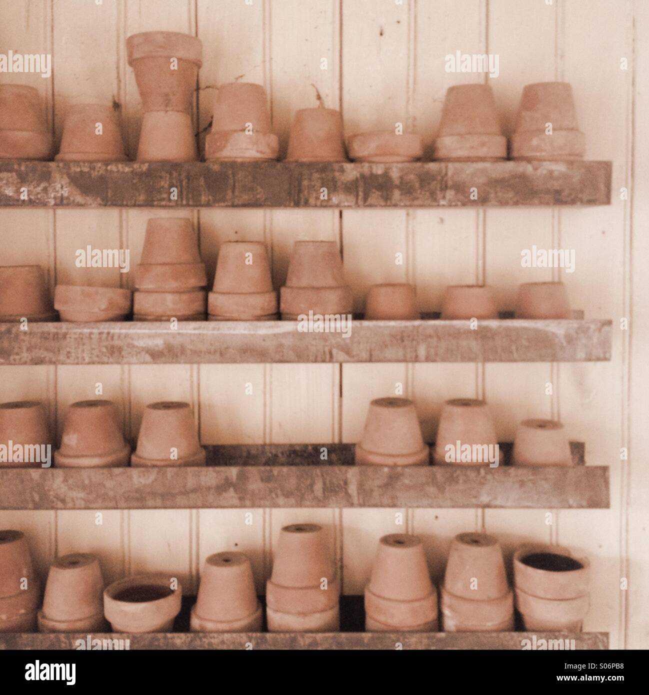 Clay gardening pots stacked in shed - Smartphone Captured Stock Image