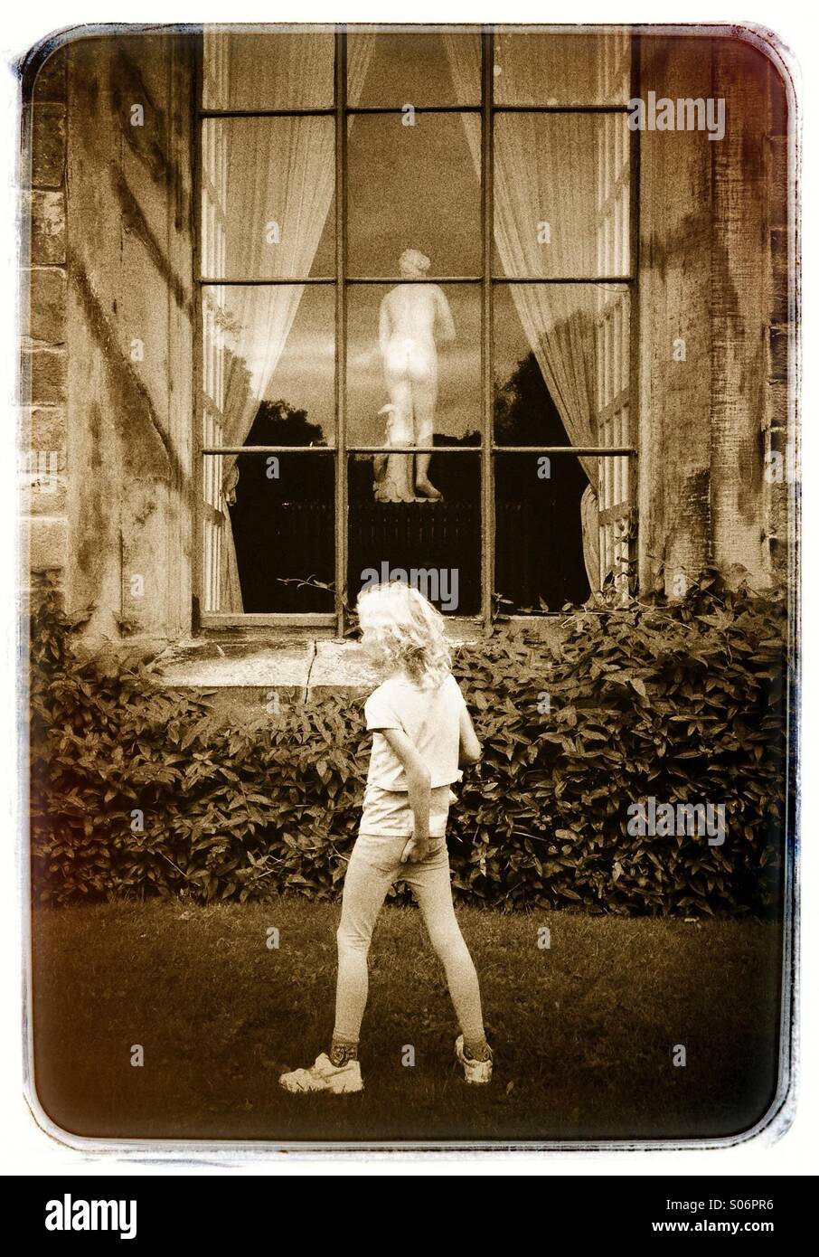 Young girl scratching her bottom looking at the bottom of