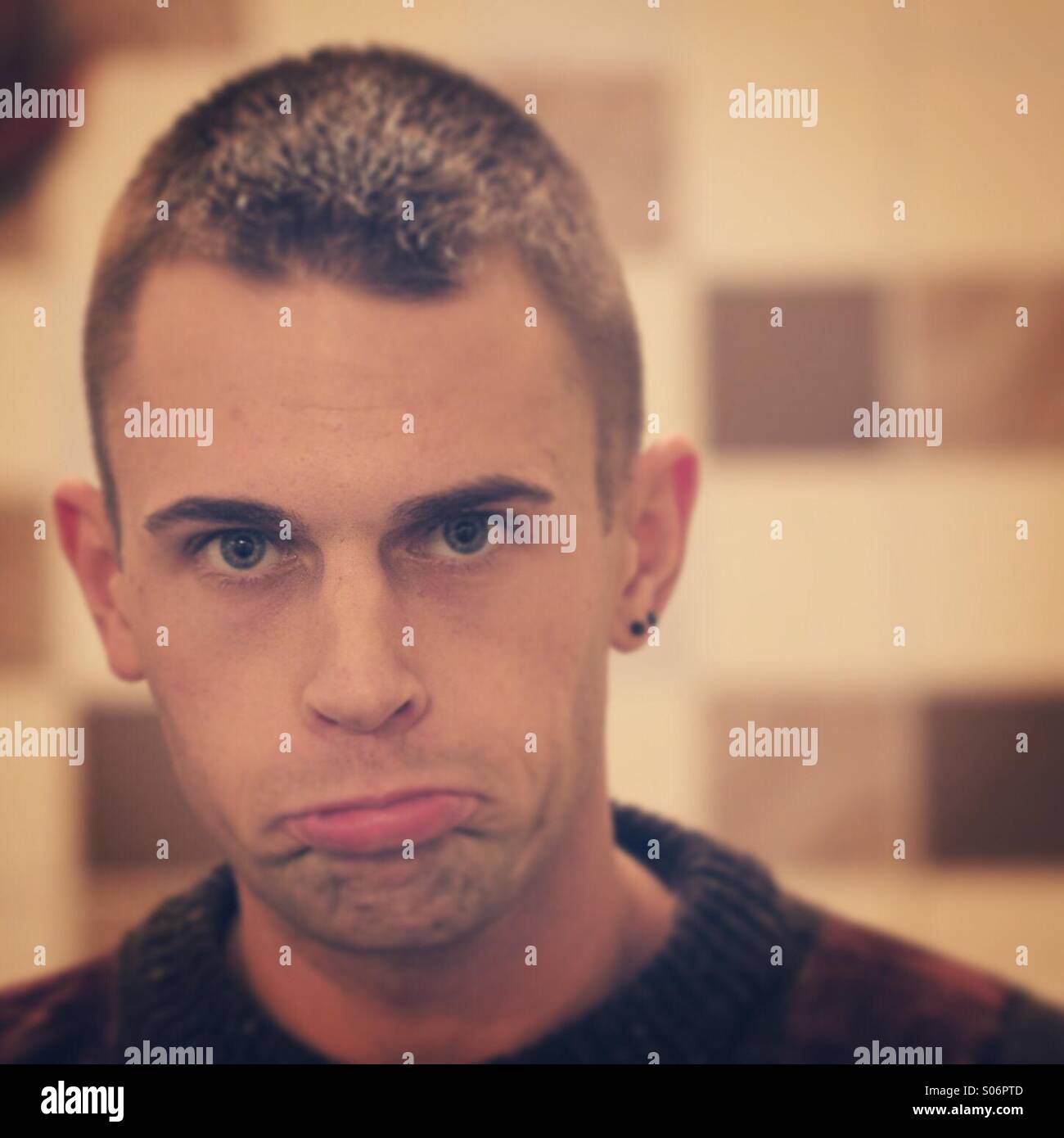 Young Man pulling silly sad face - Smartphone Captured Stock Image