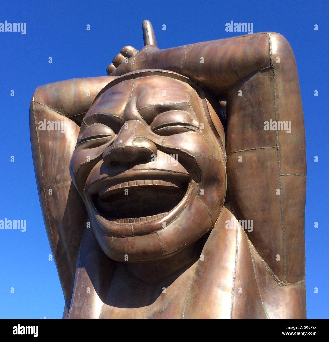 A-Maze-ing Laughter, hugely popular public outdoor art installation by Yue Minjun, English Bay, Vancouver, BC, - Smartphone Captured Stock Image